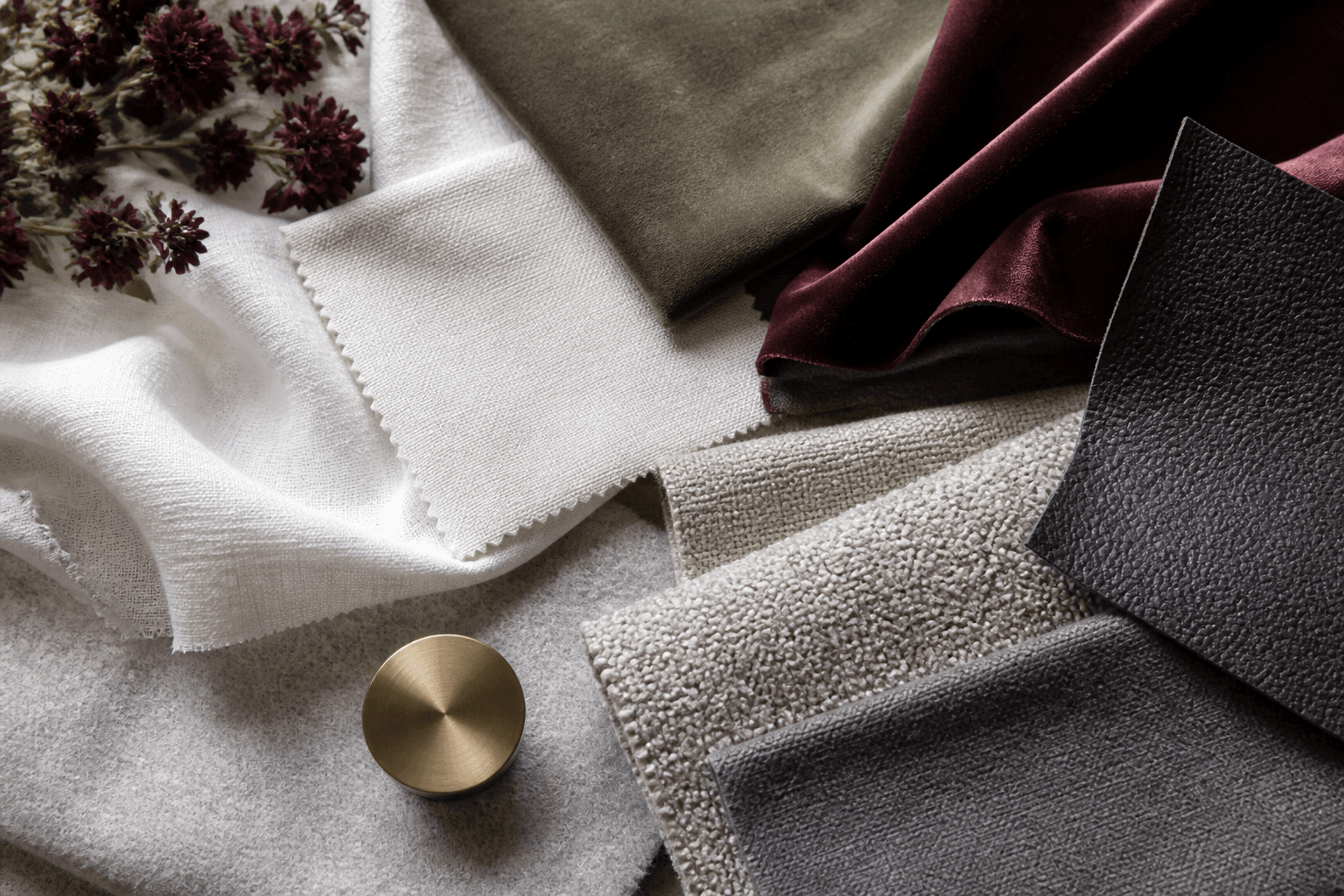 Layered linen, cotton, velvet, wool, leather and boucle fabric samples
