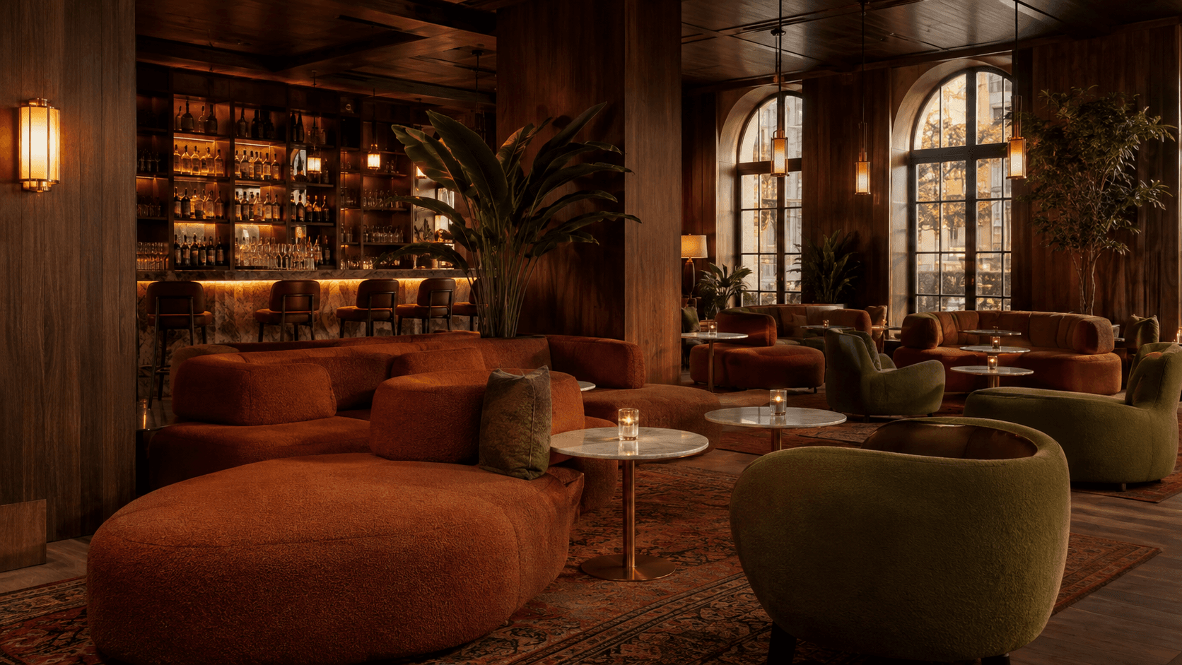 Warm hospitality lounge with dark walnut paneling, terracotta and olive seating and a backlit bar
